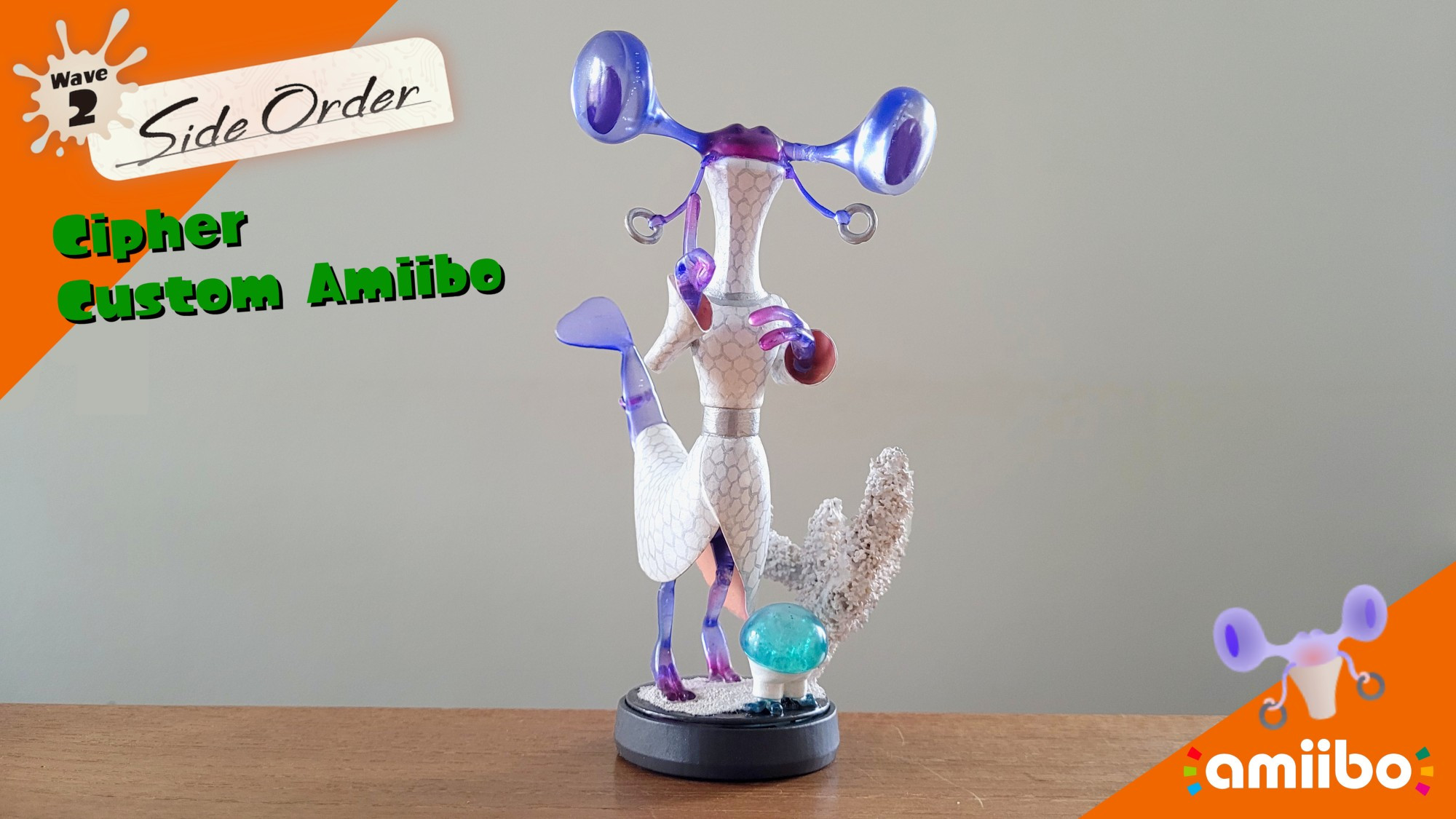 A custom Amiibo figurine of Cipher. It stands on a small black disc that makes up the base of the figurine, and standing with it is a piece of bleached coral and a small blue jellyfish in white shorts.